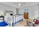 Bright bedroom featuring a metal frame bed, a wooden dresser, and a comfortable seat at 6294 Highway 165, Ravenel, SC 29470