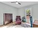 Bedroom with hardwood floors, ceiling fan, and a comfortable armchair with ottoman at 6294 Highway 165, Ravenel, SC 29470