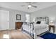 Comfortable bedroom featuring a metal bed frame, hardwood floors, and neutral color palette at 6294 Highway 165, Ravenel, SC 29470