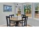 Bright breakfast nook with wood table, four chairs, decorative light fixture, and a bay window at 6294 Highway 165, Ravenel, SC 29470