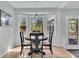 Sunlit breakfast nook with hardwood floors, white trim, large bay window, and decorative light fixture at 6294 Highway 165, Ravenel, SC 29470