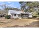 The exterior features a screened-in porch, patio, and well-maintained lawn space at 6294 Highway 165, Ravenel, SC 29470