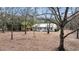 Charming white home with metal roof surrounded by mature trees and natural landscaping at 6294 Highway 165, Ravenel, SC 29470