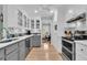 Stylish kitchen with glass front cabinets, stainless steel appliances, and sleek countertops at 6294 Highway 165, Ravenel, SC 29470