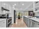 Open kitchen layout with stainless steel appliances, light countertops, and breakfast nook view at 6294 Highway 165, Ravenel, SC 29470