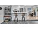 Kitchen island with breakfast bar and stool seating, stainless steel appliances, and custom cabinets at 6294 Highway 165, Ravenel, SC 29470