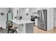Bright kitchen with stainless steel appliances, hardwood floors, and a peninsula island with bar stools at 6294 Highway 165, Ravenel, SC 29470