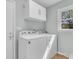 Bright laundry room featuring a new washer and dryer, cabinets and a window offering natural light at 6294 Highway 165, Ravenel, SC 29470