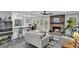 Cozy living room features a brick fireplace, ceiling fan, and open floor plan with views of the backyard at 6294 Highway 165, Ravenel, SC 29470
