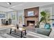 Cozy living room with brick fireplace and exposed beam ceiling at 6294 Highway 165, Ravenel, SC 29470