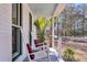 Charming porch with rocking chairs, offering a relaxing outdoor space overlooking mature trees at 6294 Highway 165, Ravenel, SC 29470