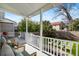 Inviting back porch featuring comfortable seating, gray flooring, and a view of the landscaped backyard at 721 Meeting St, Charleston, SC 29403