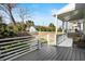 Relaxing back porch offering a peaceful retreat with gray flooring and white railing overlooking the backyard at 721 Meeting St, Charleston, SC 29403