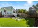Beautifully landscaped backyard features artificial turf, stepping stone accents, and a charming porch at 721 Meeting St, Charleston, SC 29403