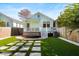 Charming backyard with artificial turf, stepping stones, and a cozy porch, perfect for outdoor entertaining at 721 Meeting St, Charleston, SC 29403