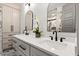 Bathroom features a double sink, arched mirrors, and storage cabinets at 721 Meeting St, Charleston, SC 29403