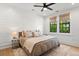 Relaxing bedroom with a ceiling fan, two windows, and wooden floors under a plush rug at 721 Meeting St, Charleston, SC 29403