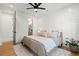 Bedroom features a ceiling fan, wooden floors and an ensuite bathroom off of the sleeping area at 721 Meeting St, Charleston, SC 29403