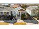 Charming home with tidy landscaping, features welcoming front porch and inviting curb appeal at 721 Meeting St, Charleston, SC 29403