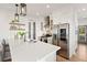 Open kitchen with stainless steel appliances, custom cabinetry, and a large island with bar seating at 721 Meeting St, Charleston, SC 29403