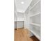 Spacious walk-in closet with custom shelves and hardwood floors at 721 Meeting St, Charleston, SC 29403