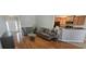 Inviting living area with hardwood floors, comfortable sofas, and a view of the kitchen, ideal for modern living at 7646 Kinston St, North Charleston, SC 29418
