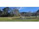 Picturesque pond features a fountain, lush green lawn, and surrounding trees, creating a tranquil community space at 7646 Kinston St, North Charleston, SC 29418