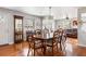 Open-concept dining room with wood floors, large windows, dining table and chairs for hosting Gathering gatherings at 907 Pauline Ave, Charleston, SC 29412