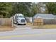 This view showcases a truck and trailer, complemented by a secure wooden gate and a paved driveway at 907 Pauline Ave, Charleston, SC 29412
