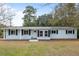 Charming single-story home featuring a welcoming porch, complemented by dark shutters at 907 Pauline Ave, Charleston, SC 29412