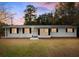 Charming single-story home with freshly painted white siding, black shutters, and a well-manicured front yard at 907 Pauline Ave, Charleston, SC 29412