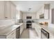 Modern white kitchen with marble countertops, stainless steel appliances, subway tile backsplash, and ample cabinet space at 907 Pauline Ave, Charleston, SC 29412