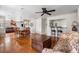 Spacious living room with wood floors, ceiling fan, a dining table, and a view into the kitchen at 907 Pauline Ave, Charleston, SC 29412