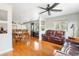 Open living room featuring wood floors, a leather sofa, a dining table and large windows at 907 Pauline Ave, Charleston, SC 29412