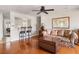 Inviting living space with hardwood floors, ceiling fan, sofa, and decorative trunk, offering cozy elegance at 907 Pauline Ave, Charleston, SC 29412