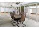 Spacious screened porch with tiled table, ceiling fans, and ample seating, perfect for outdoor dining at 907 Pauline Ave, Charleston, SC 29412