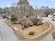 Aerial view of a well-kept brick home with a circular driveway and mature trees in a suburban neighborhood at 101 S Gateshead Crossing, Goose Creek, SC 29445