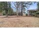 Lush backyard view showcases mature trees, a glimpse of the house's screened porch, and inviting outdoor space at 101 S Gateshead Crossing, Goose Creek, SC 29445