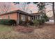 Lush backyard showcasing a screened-in porch, mature landscaping, and glimpses of the surrounding neighborhood at 101 S Gateshead Crossing, Goose Creek, SC 29445