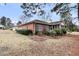 Expansive backyard with a brick home featuring a screened porch and lush green lawn at 101 S Gateshead Crossing, Goose Creek, SC 29445