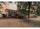 View of a brick home's screened-in porch overlooking a large backyard with mature trees at sunset at 101 S Gateshead Crossing, Goose Creek, SC 29445