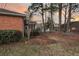 A charming backyard with a lush lawn, mature trees, and a peek at a screened porch at 101 S Gateshead Crossing, Goose Creek, SC 29445