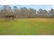 A baseball field surrounded by tall trees with a covered dug out and chain link fence, offering a natural and private setting at 101 S Gateshead Crossing, Goose Creek, SC 29445