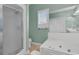 A bathroom with a tub, a shower, a large mirror, and a window with white shutters at 101 S Gateshead Crossing, Goose Creek, SC 29445