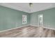 A bedroom with a ceiling fan, a window, and light wood floors leads to the ensuite bathroom at 101 S Gateshead Crossing, Goose Creek, SC 29445