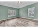 A bedroom with two windows dressed with white shutters, a ceiling fan, and light wood floors at 101 S Gateshead Crossing, Goose Creek, SC 29445