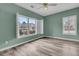 Bright bedroom featuring updated floors, green walls, ceiling fan, and natural light through shuttered windows at 101 S Gateshead Crossing, Goose Creek, SC 29445