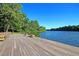 A wooden community dock with benches overlooking a calm river surrounded by green trees at 101 S Gateshead Crossing, Goose Creek, SC 29445