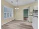 Well-lit dining area features plantation shutters, modern chandelier and beautiful wood-look flooring that extends into the adjoining kitchen space at 101 S Gateshead Crossing, Goose Creek, SC 29445