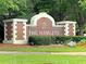 A brick sign reads 'The Hamlets' in white lettering, surrounded by greenery and a manicured lawn at 101 S Gateshead Crossing, Goose Creek, SC 29445